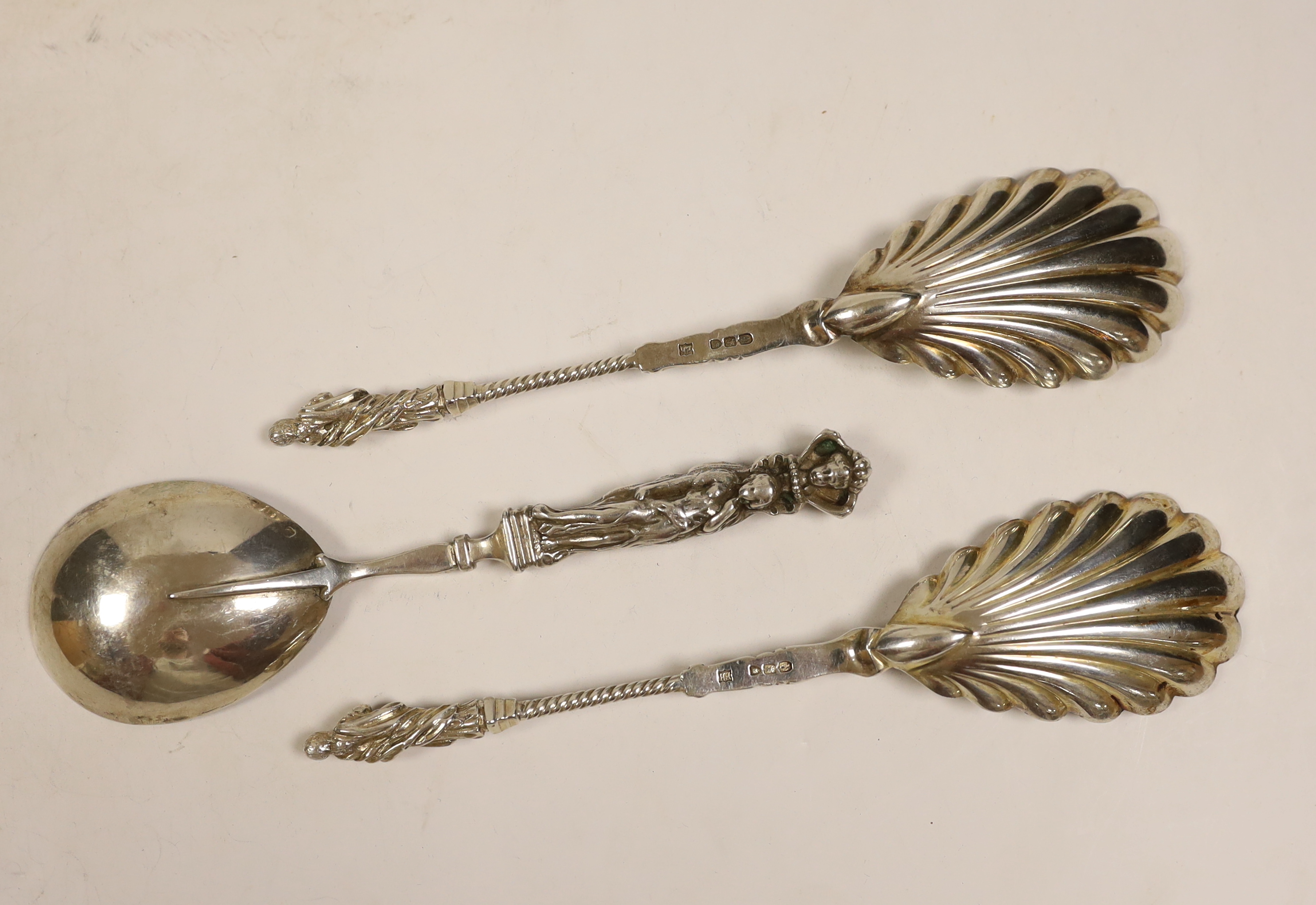 A pair of late Victorian silver apostle spoons with shall bowls, Edward Hutton, London, 1891, 20.3cm and a similar French? white metal spoon.